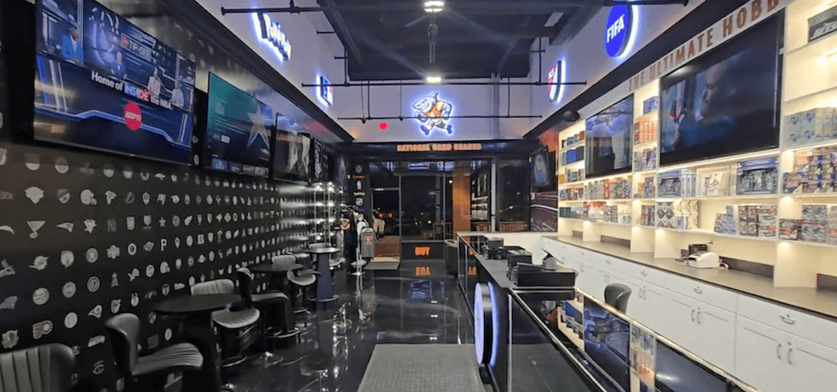 NCS shop interior with multiple TVs, chairs, and branded decor.