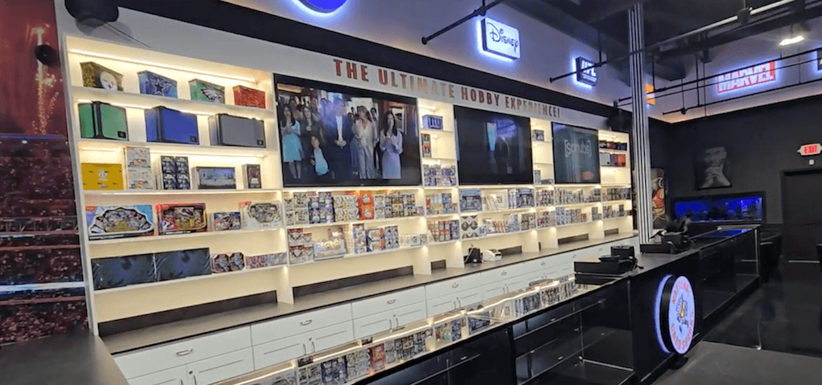 Display case with various items and screens in a store setting